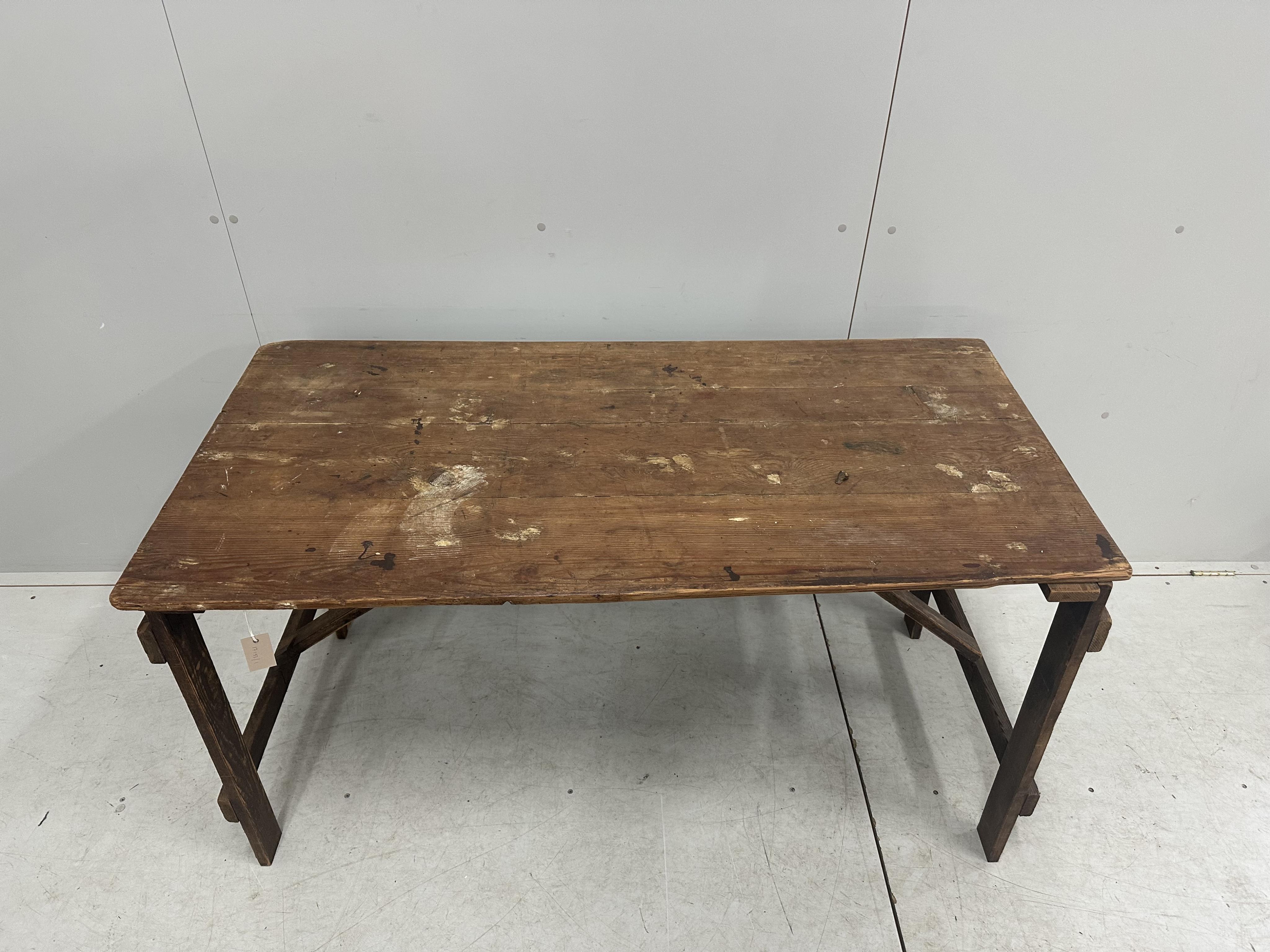 A folding pine trestle table, width 136cm, depth 67cm, height 74cm. Condition - poor